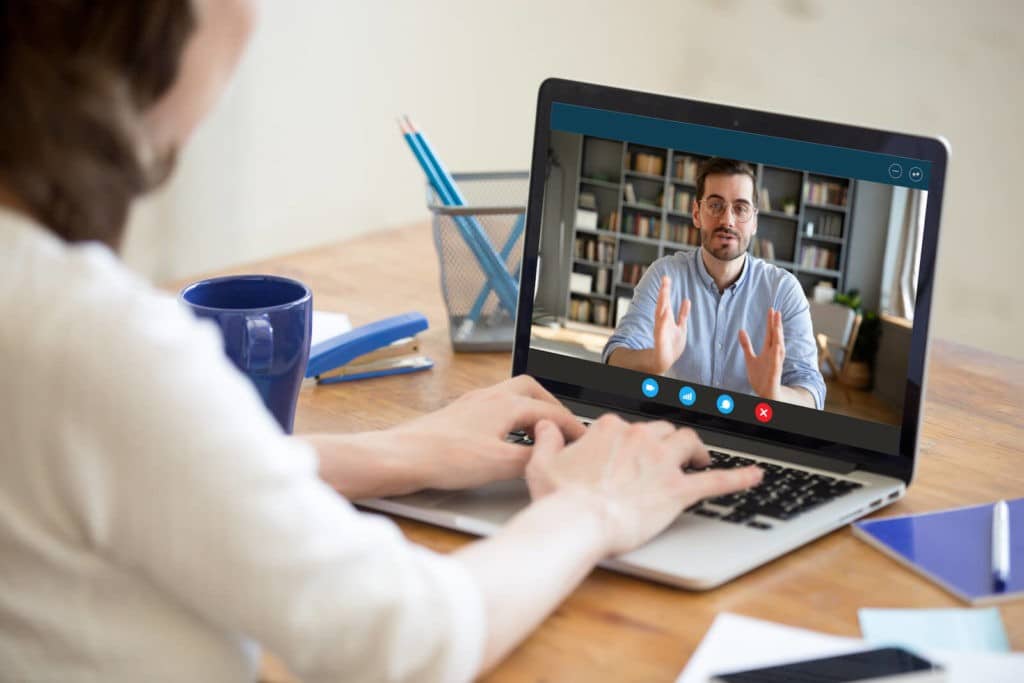 A man and woman talking over a Zoom video call.