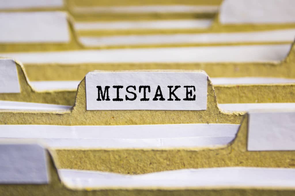 Files folders together with one labeled ‘Mistake’.