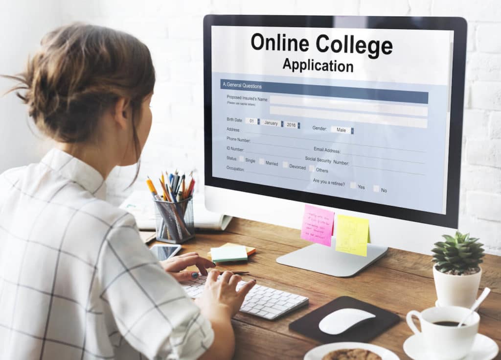 A woman looks at a master’s degree on the computer.