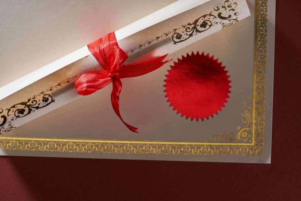 Close-up of a blank, gold-trimmed certificate.