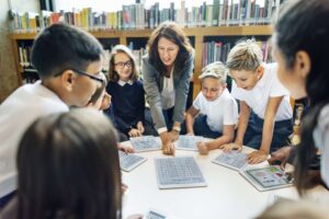A teacher and her students use their tablets for a class lesson.