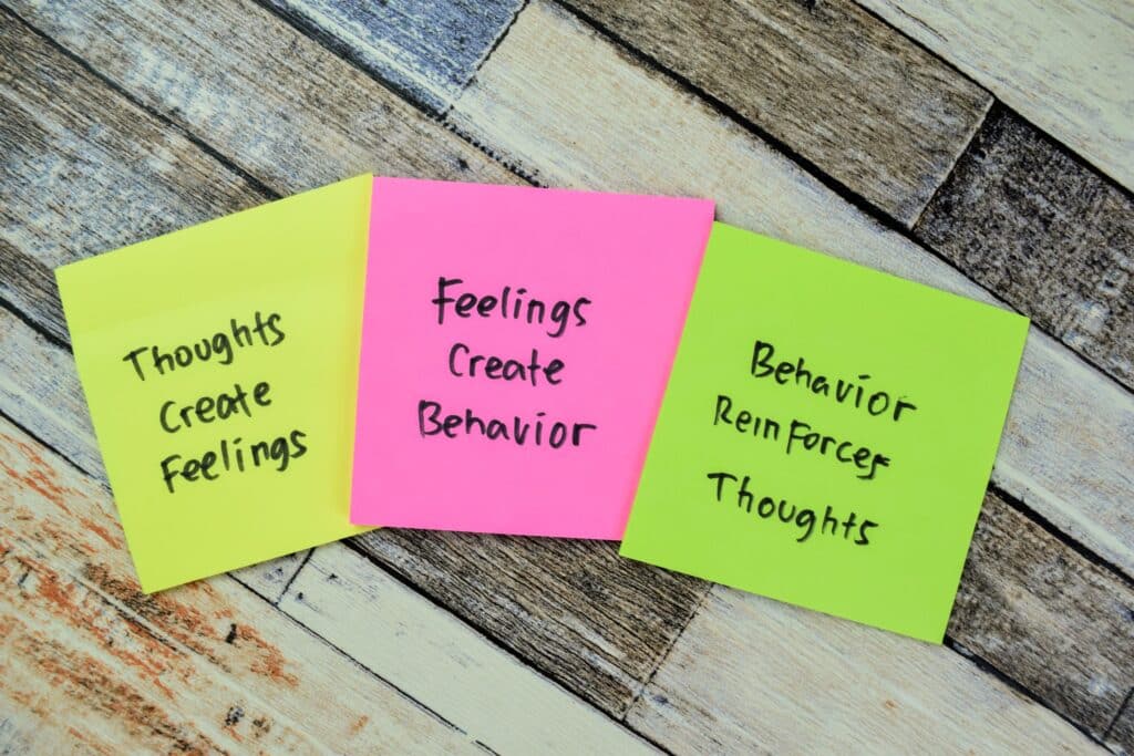 Cognitive behavioral therapy strategies are written out on Post-It notes.