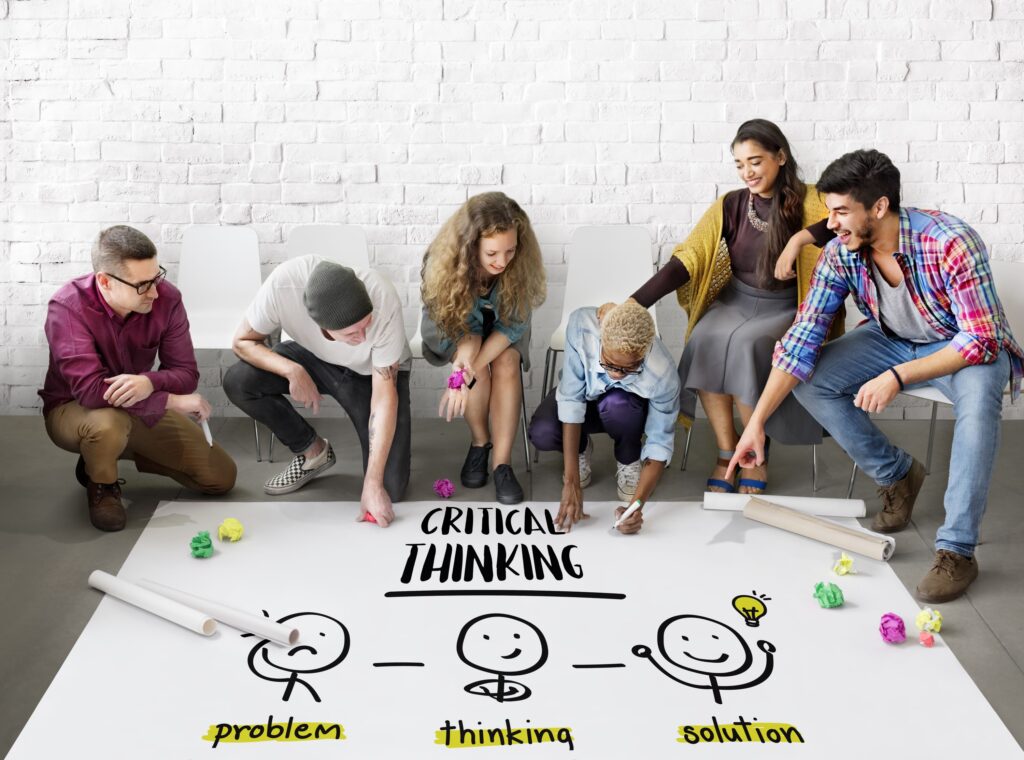A group of people works on making a poster about critical thinking skills.