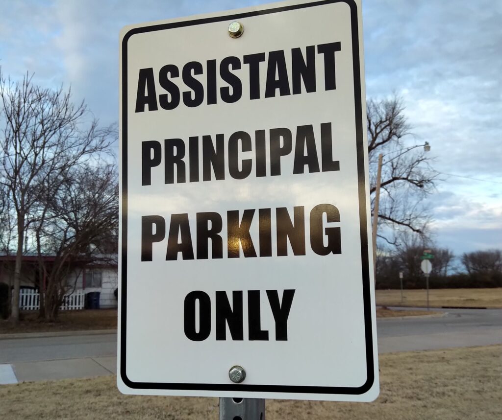 A picture of a sign that says, “assistant principal parking.”