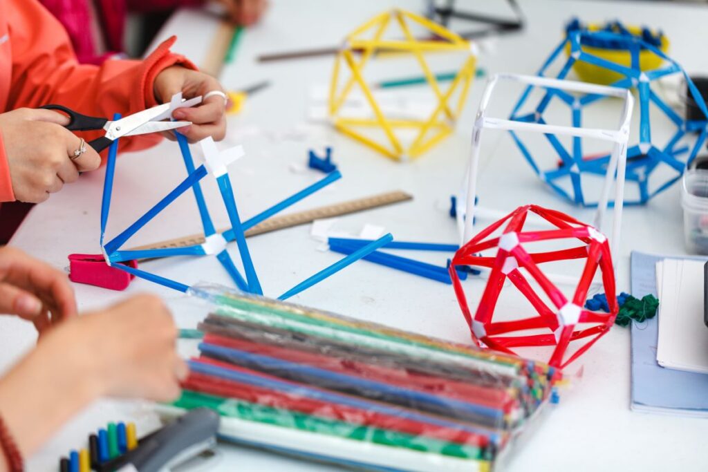 Students participate in STEM activities in school, making inventions out of straws.